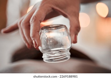 Cupping therapy, glass vacuum cup in hand and woman at spa, therapist with deep tissue massage and wellness. Closeup, treatment at luxury resort with cosmetic, body care and health with acupuncture