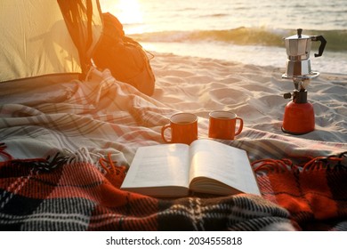 Cups, Book On Blanket And Backpack In Camping Tent. View From Inside