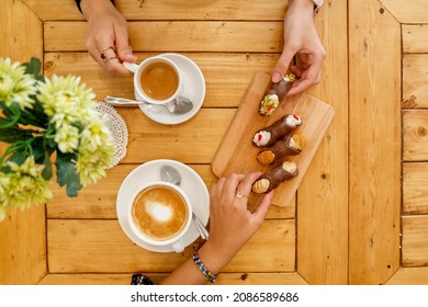 Cups Of Cappuccino And Fresh Ricotta Cannoli Dessert In Coffee Bar In Sicily, Italy. Cannoli Is A Traditional Sicilian Dessert
