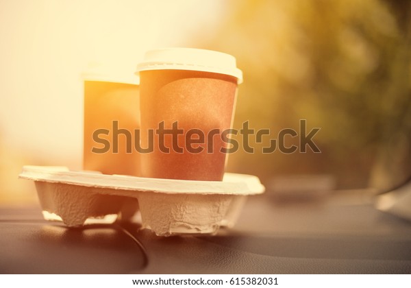 cups of coffee in car interior\
