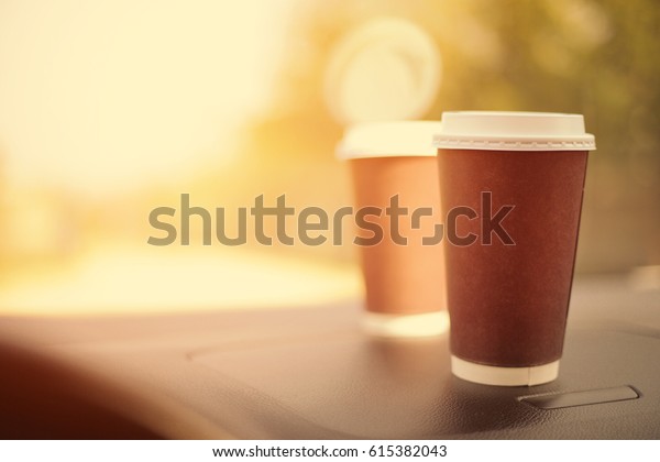 cups of coffee in car interior\
