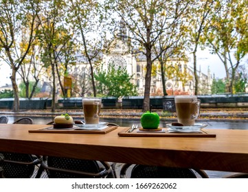 Cups Of Coffee And Delicious Deserts In A Café Opposite To Notre-Dame De Paris Cathedral, France