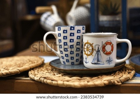 Cups with nautical pattern on table