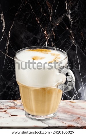 Cups of tasty hot coffee drink with milk foam.