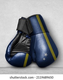 Curacao Boxing Gloves on flor with country flag painted on