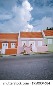 Curacao, Colorful Bouldings Around Willemstad Punda And Otrobanda Pietermaai District, Multicolored Homes In Pietermaai Curacao Caribean Island , Couple Men And Woman On Vacation Curacao