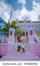 Curacao, Colorful Bouldings Around Willemstad Punda And Otrobanda Pietermaai District, Multicolored Homes In Pietermaai Curacao Caribean Island , Couple Men And Woman On Vacation Curacao