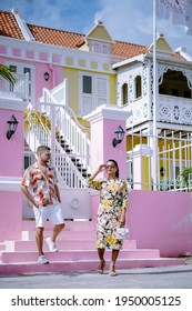 Curacao, Colorful Bouldings Around Willemstad Punda And Otrobanda Pietermaai District, Multicolored Homes In Pietermaai Curacao Caribean Island , Couple Men And Woman On Vacation Curacao