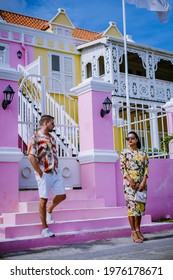 Curacao, Colorful Bouldings Around Willemstad Punda And Otrobanda Pietermaai District, Multicolored Homes In Pietermaai Curacao Caribean Island , Couple Men And Woman On Vacation Curacao