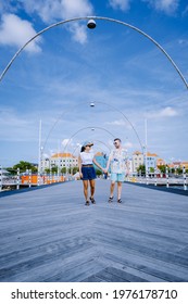 Curacao, Colorful Bouldings Around Willemstad Punda And Otrobanda Pietermaai District, Multicolored Homes In Pietermaai Curacao Caribean Island , Couple Men And Woman On Vacation Curacao