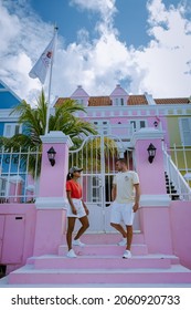 Curacao, Colorful Bouldings Around Willemstad Punda And Otrobanda Pietermaai District, Multicolored Homes In Pietermaai Curacao Caribean Island , Couple Men And Woman On Vacation Curacao