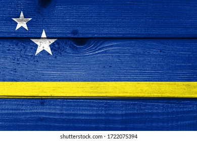 Curacao flag painted on old wood plank background. Brushed natural light knotted wooden board texture. Wooden texture background flag of Cura?ao.