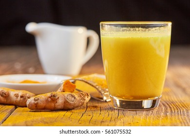 Curcuma root for golden milk on brown wooden table