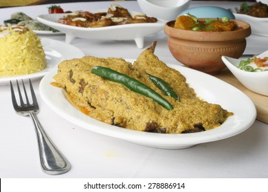 Curd Based Fish Curry In Which Fish Cooked In Yogurt Based Mustard Sauce, Which Is Also Called As 