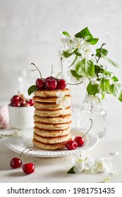 Curd pancakes with cherries. Spring mood. - Shutterstock ID 1981751435