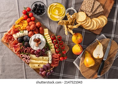 Cured cheese and meze platter setup rich in variety of fruits, cheese, meat and crackers