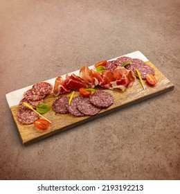 Cured Meat Platter With Prosciutto And Salami Decorated With Cherry Tomatoes