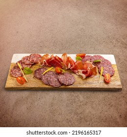 Cured Meat Platter With Prosciutto And Salami Decorated With Cherry Tomatoes