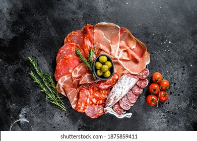 Cured meat platter of traditional Spanish tapas. Chorizo, jamon serrano, lomo and fuet. Black background. Top view. - Shutterstock ID 1875859411