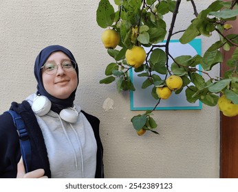 Curiosity and Growth: Woman Admiring Quince Tree, Symbolizing Connection to Nature, Knowledge, and Personal Growth in a Quiet Moment of Reflection - Powered by Shutterstock