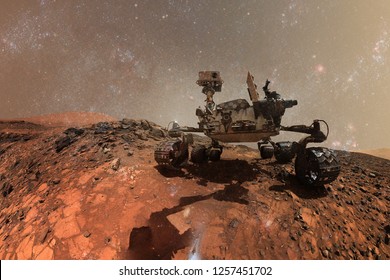 Curiosity Mars Rover exploring the surface of red planet. Elements of this image furnished by NASA.