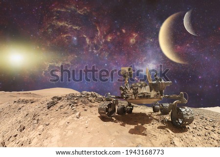 Curiosity Mars Rover exploring the surface of red planet. Elements of this image furnished by NASA.