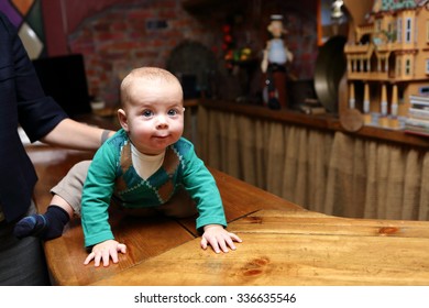 The Curious Baby Crawling On The Bar