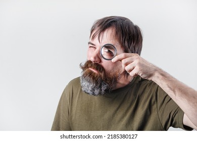 Curious Bearded Man See Through Magnifying Glass. Science And Curiosity Concept.