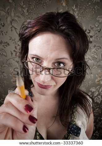 Curious brunette woman pointing with yellow pencil