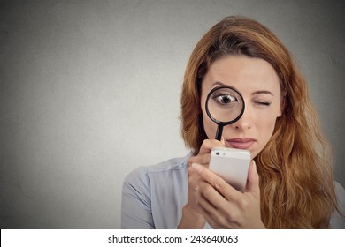 Curious. Business Woman Looking Through Magnifying Glass On Smart Phone Screen Isolated Grey Background. Human Face Expression. Investigator Searching. Security Safety Concept. Complicated Technology