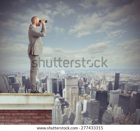 Curious businessman looks beyond with his binoculars