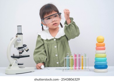 Curious child conducting experiments with a microscope and colorful test tubes, exploring the wonders of science and learning. - Powered by Shutterstock