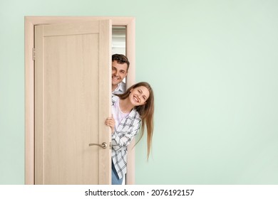 Curious Couple Looking Out The Door