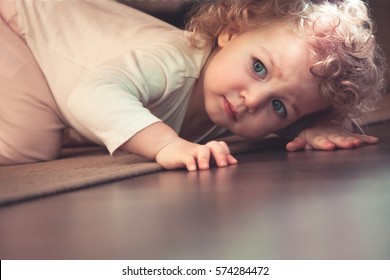 Curious Cute Child Hiding Under The Bed In Kids Room And Looking Scared