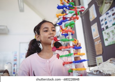 Curious elementary student looking at model in classroom
