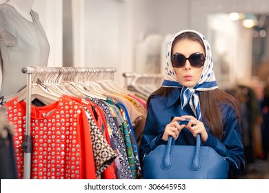 Curious Girl in Blue Trench Coat and Sunglasses Shopping - Surprised retro young woman in a raincoat in a clothing store
