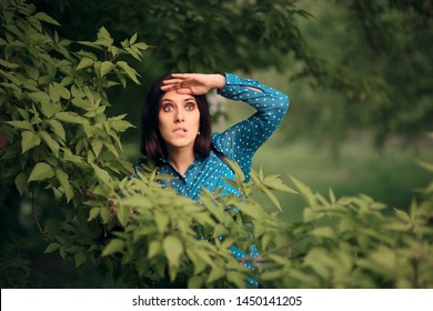 Curious Jealous Woman Spying from Bushes. Funny undercover girl stalking outdoors in surveillance mode
