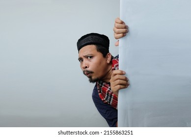 Curious Man Peeking Behind The Wall