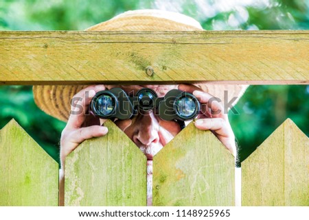 Similar – a curious neighbour looks over a garden fence