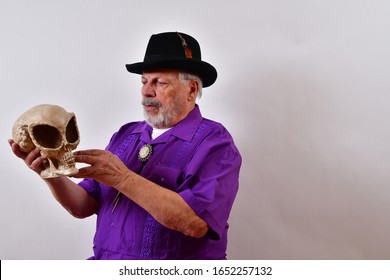 Curious old man studying an alien skull  Dapper old man intriqued by the alien skull  Sharp dressed senior man with an alien skull