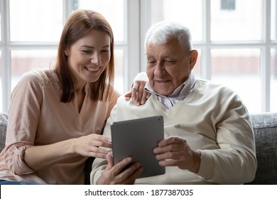 Curious Older Father Digital Tablet User Asking Adult Daughter For Help To Buy Purchase Goods At Web Shop. Proud Elderly Man Dad Sharing With Young Woman Grown Child Success In Working On Pad Computer
