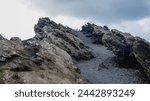 Curious rock formations next to the path bordering the crater of a volcano on the island of La Palma