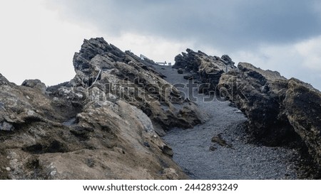 Curious rock formations next to the path bordering the crater of a volcano on the island of La Palma
