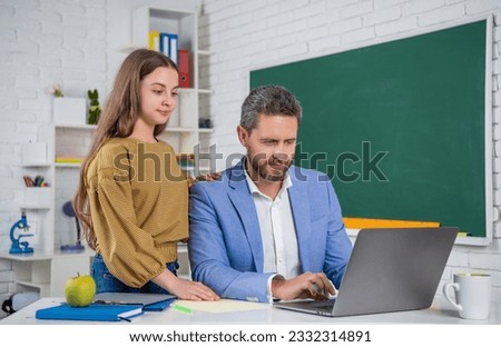 curious teen kid with man teacher in classroom. education