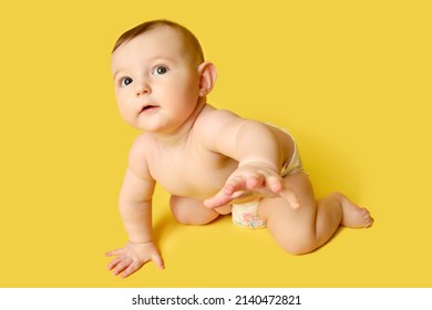 Curious Toddler Baby Crawling On Studio Yellow Background. Funny Child Boy With Surprise On His Face, Copy Space