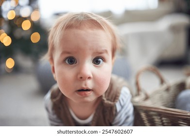 Curious toddler exploring a cozy living room during the holiday season with a warm atmosphere - Powered by Shutterstock