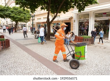 Curitiba, Paraná, Brazil - September 15, 2020 - Worker pushing a garbage collection cart to clean the streets of the city of Curitiba.