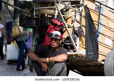 Curitiba/ Paraná/ Brazil- 
Waste Picker In Downtown With A Small Car Full Of Cardboards.