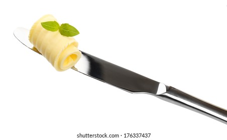 Curl Of Fresh Butter With Basil On Knife, Isolated On White