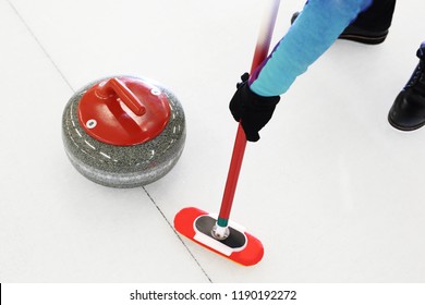 Curling game. The player plays curling on the ice rink
